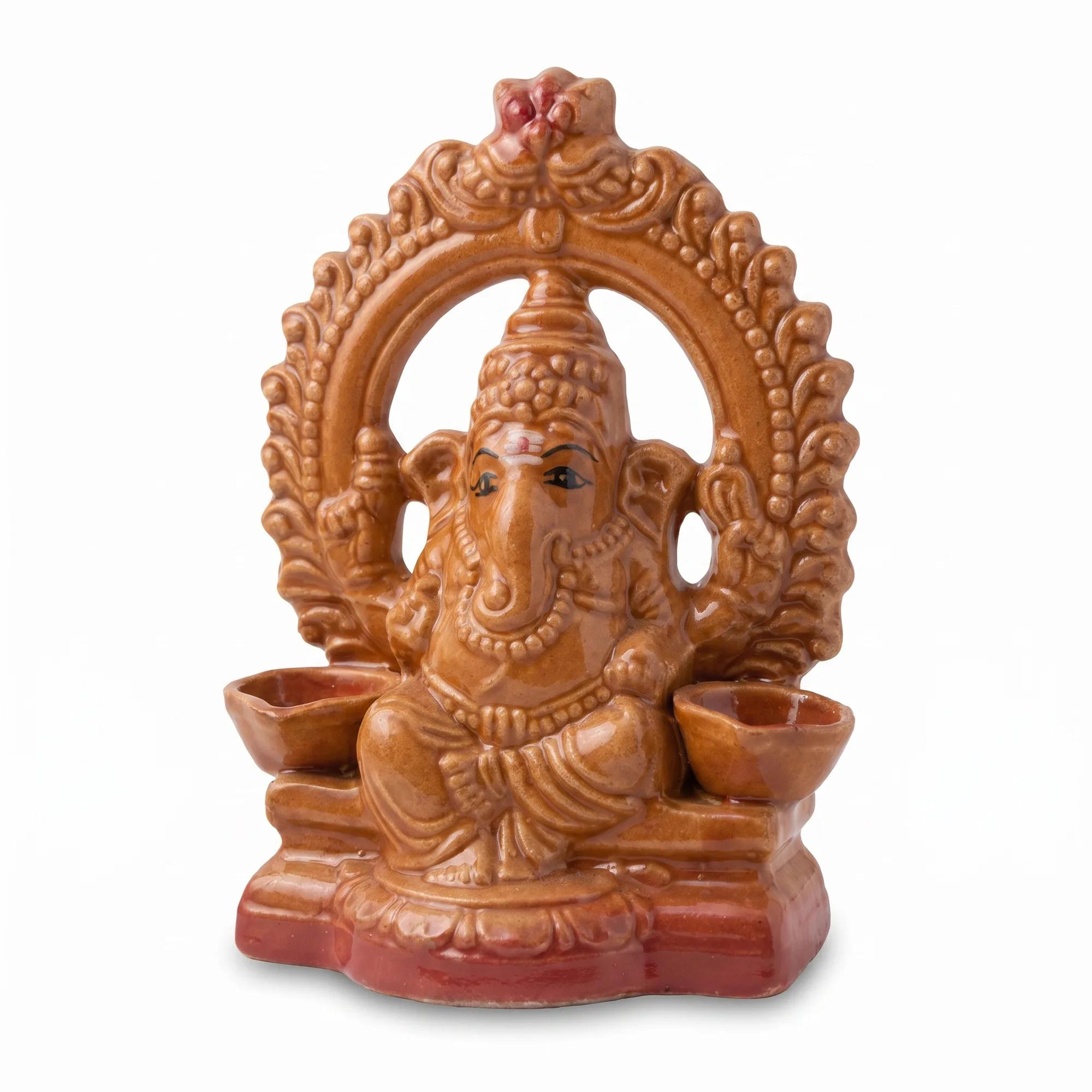 Single ceramic Ganesha idol with twin diya holders, shown on a plain white background.