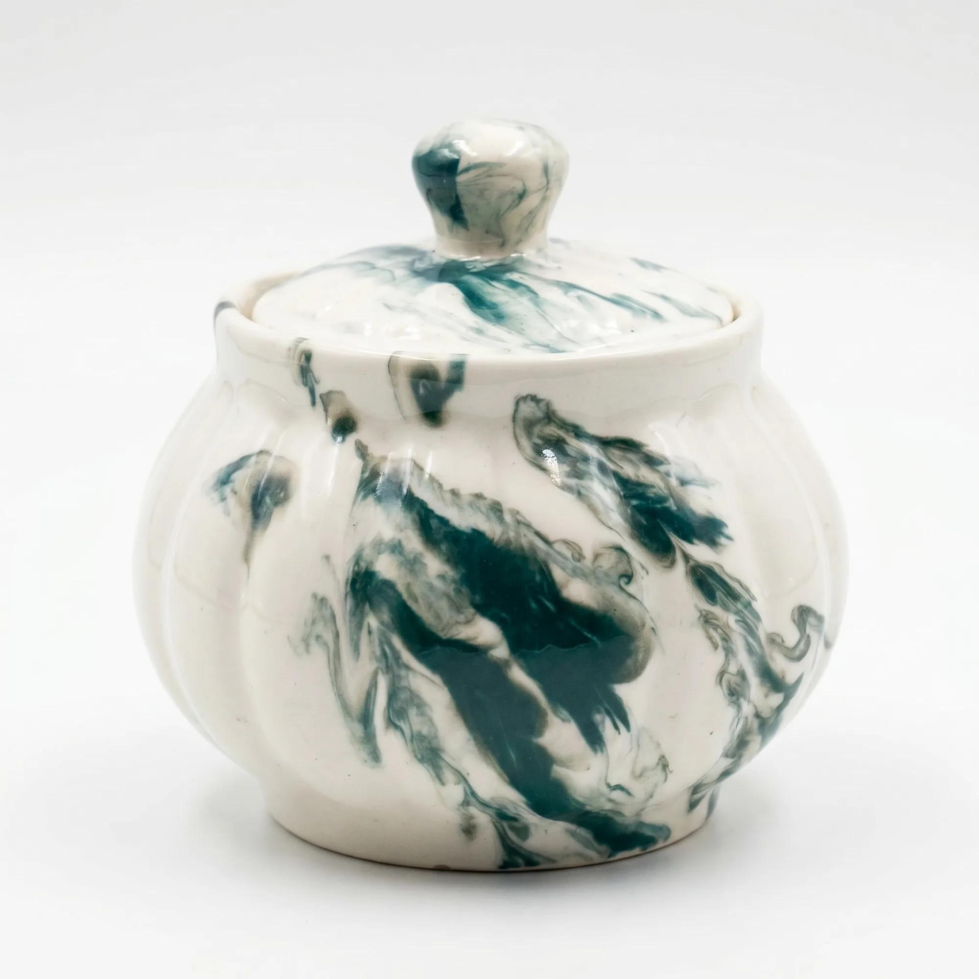 A close-up view of the 400ml green swirl ceramic storage pot against a plain white background.