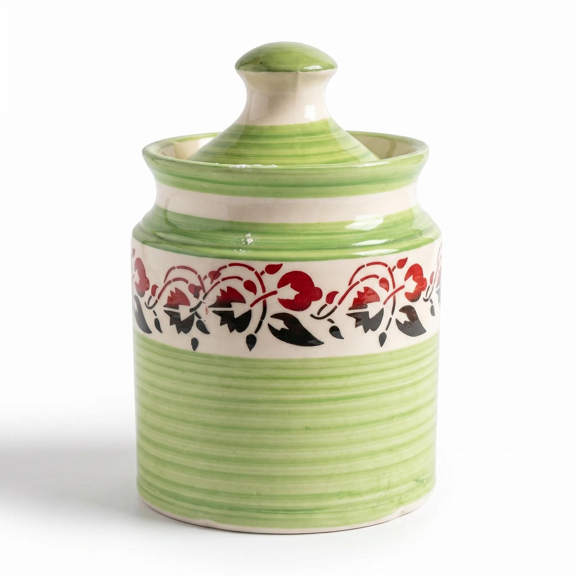 A full-front view of the green floral ceramic storage jar with its lid on a plain white background.