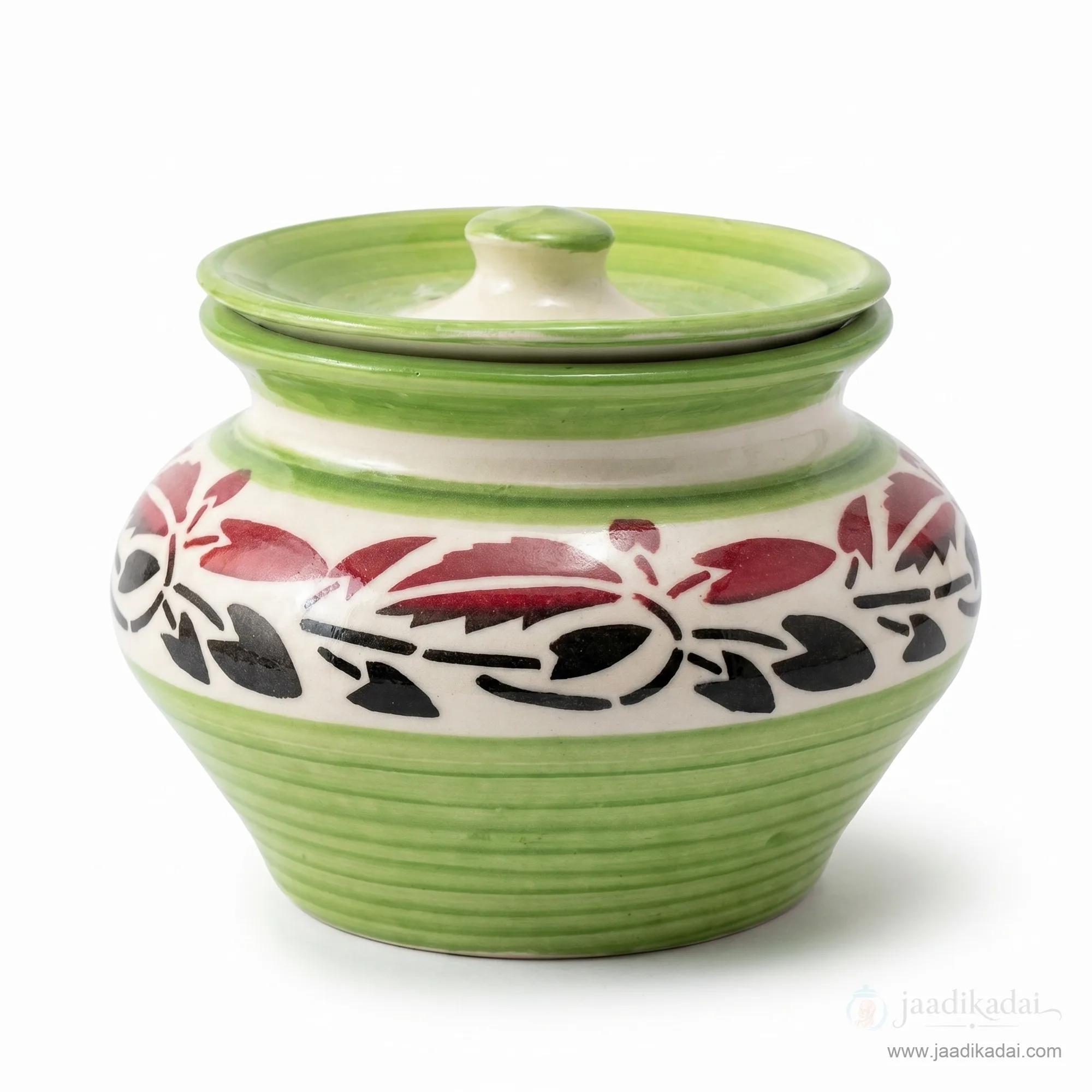 Front view of the green floral ceramic storage pot with lid on a white background.