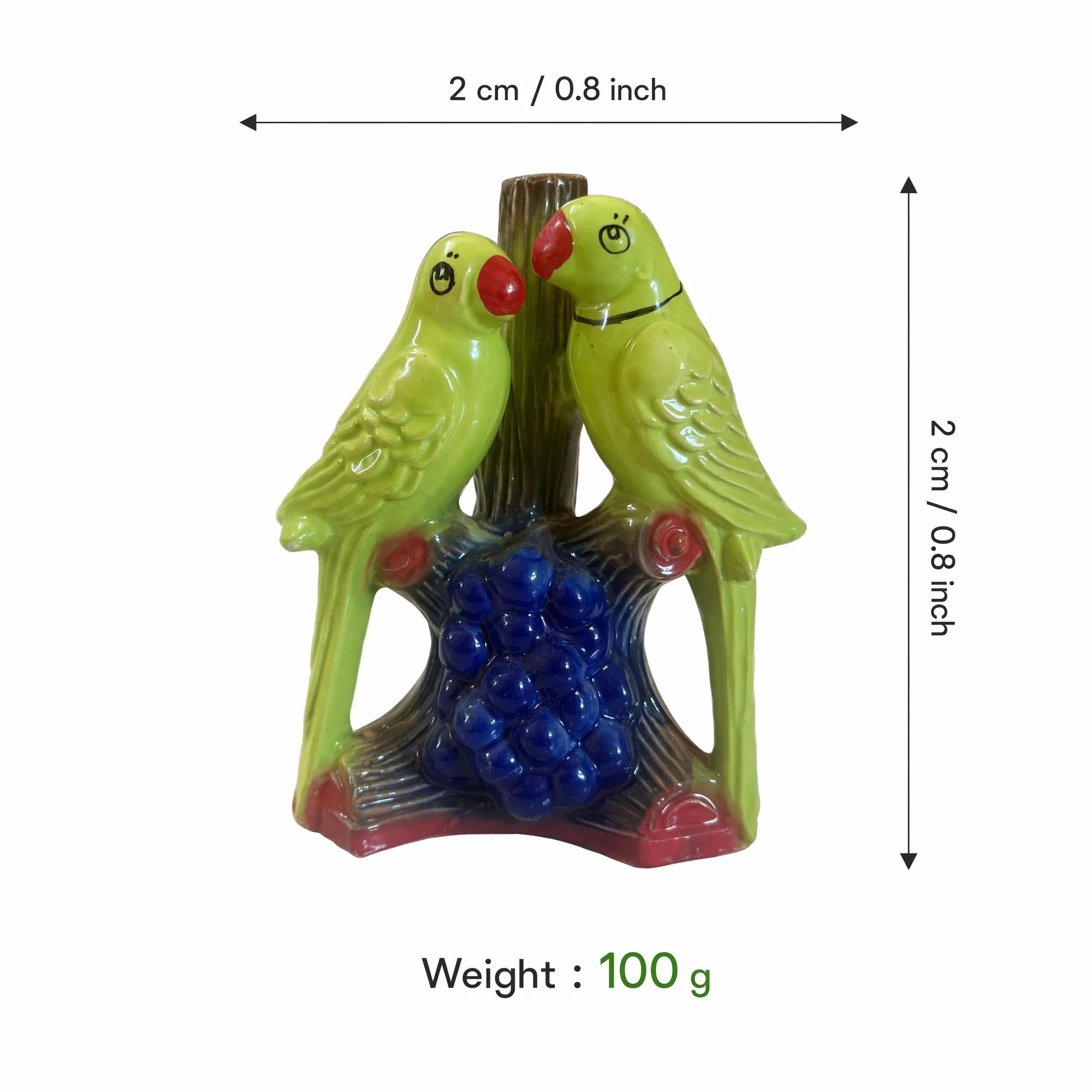 An image displaying the dimensions and weight of the green ceramic parrot pair showpiece.