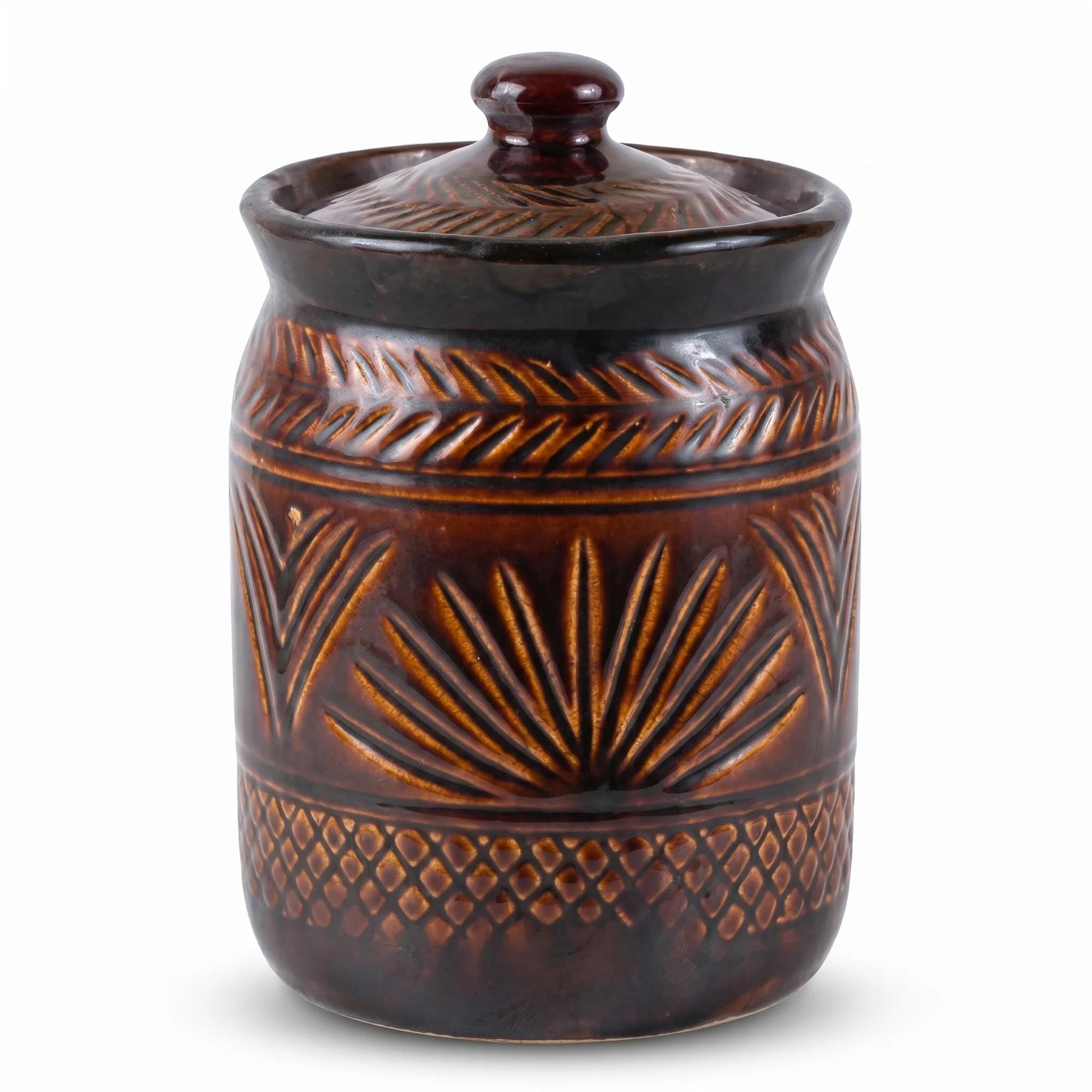 Close-up view of the brown embossed ceramic storage jar with its lid on a white background.