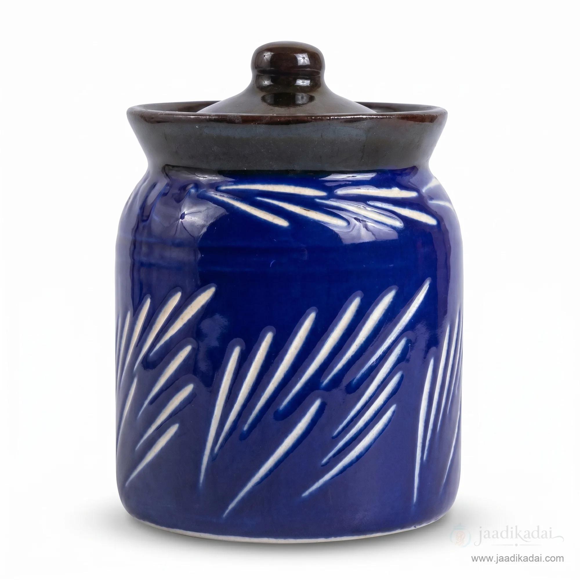 A front view of the cobalt blue ceramic storage jar with its dark lid, isolated on a white background.
